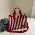 Stylish red and white striped canvas tote bag with dual pockets and removable strap - Red