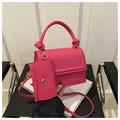 Detail of pink crossbody bag with knotted handle, gold hardware and mini coin purse - Rose Pink