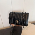 Elegant black quilted crossbody bag with gold floral clasp and chain strap - Black
