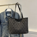 Gray tote bag with black polka dots, bow charm, and leather straps for commuting - Bow