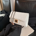 White quilted crossbody bag with golden clover clasp and dark metal chain strap - White
