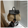 Detail of hand-woven straw backpack with black leather straps and drawstring closure - Black
