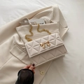 Elegant cream quilted crossbody bag with gold bow clasp and metal chain strap - Off White