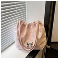 Detail of light pink pleated hobo bag with an elegant silver metal bow on front - Pink