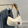 Minimalist beige canvas tote bag with a colorful striped woven shoulder strap - White