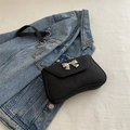 Chic black crossbody bag with silver metal bow accent and elegant chain strap - Black