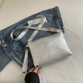 Silver crocodile texture crossbody bag with wide strap on a casual denim background - Silver