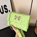 Neon green quilted crossbody bag with silver bow accent and chain strap for women - Green
