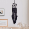 Handmade bohemian black dream catcher with macrame tassels and feathers on a white wall - Black Lotus Style / Black