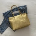 Golden tote bag with crocodile texture finish and spacious minimalist design for women - Gold