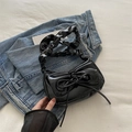 Chic black patent leather crescent bag with bow detail and ruched shoulder strap - Black