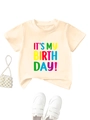 Detail of kids birthday t-shirt with colorful text print and matching accessories - 90cm / Apricot