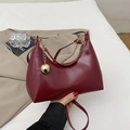 Burgundy patent leather crescent bag with oversized gold sphere charm and fashion logo - Burgundy
