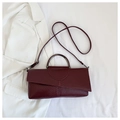 Detail of burgundy PU leather bag with snake skin and woven textures and metal handle - Burgundy