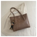 Detail of a brown tote bag with a houndstooth rabbit charm on a blazer background - With Pendant / Dark Khaki