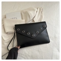 Chic black envelope clutch bag featuring silver eyelet studs and a detachable wristlet strap - Black