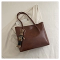 Detail of dark brown tote bag in vintage glossy leather with a cute bunny charm - With Pendant / Brown