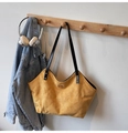 Quilted bright yellow suede tote bag with black leather handles and gold metal logo - Yellow