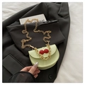 Mint green cherry buckle handbag with gold chain strap on black blazer jacket - Green
