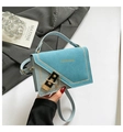 Light blue color-block shoulder bag with gold clasp and chain strap in a lifestyle setting - Blue