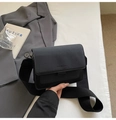 Detail of black faux leather crossbody bag with wide strap and embossed fashion text - Black