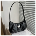 Detail of black matte leather baguette bag featuring a silver metal butterfly ornament - Black