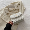 White quilted crossbody bag with golden chain strap and metallic rotary lock closure - White