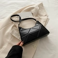 Minimalist black quilted faux leather underarm bag with geometric texture and gold hardware - Black