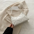 White geometric quilted underarm bag with slim shoulder strap and golden metal buckle - White