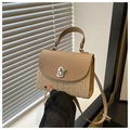 Detail of hand-woven straw texture and khaki leather flap with silver metal twist lock - Khaki