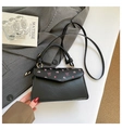 Detailed close-up of a black leather handbag with pink bow and floral print decoration - Pink Bow and Floral Pattern / Black
