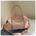 Detail of pink large travel bag showing quilted texture and HuaJiao Fashion logo - Pink