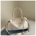 Detail of off-white travel bag featuring natural crinkled texture and branding - White