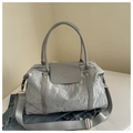 Detail of grey glossy crinkled texture bag with embossed logo and wide shoulder strap - Silver