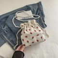 White corduroy strawberry print bucket bag with pearl beaded shoulder strap - White