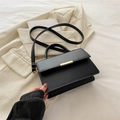 Minimalist black leather crossbody bag with elegant gold clasp and structured design - Black