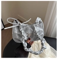 Close-up of silver velvet shoulder bag with metallic butterfly buckle and pleated strap - Silver