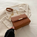 Brown V-quilted crossbody bag with gold chain strap on a beige blazer background - Brown