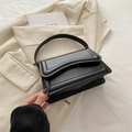 Minimalist black leather handbag with a sleek rectangular silhouette and top handle - Black