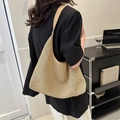 French style beige woven straw shoulder bag with leather strap on a model wearing black - Khaki