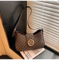 Close-up of brown leather shoulder bag with vintage M monogram pattern and gold buckle - Coffee