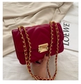 Quilted red shoulder bag with gold chain strap and metallic clasp on white fabric - Red