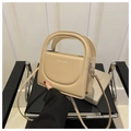Close-up of beige handbag with arched embossed design and Fashion & Bags lettering - Khaki