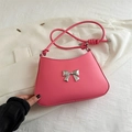 Pink crossbody bag with silver bow accent and adjustable strap for women - Pink