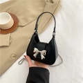 Chic black matte leather mini handbag with a silver metal bow and chain strap - Black