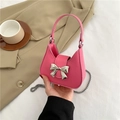 Pink crossbody bag with silver bow accent and chain strap for women in trendy style - Rose Red