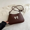 Dark brown faux leather underarm bag with a silver metal bow accent and knotted straps - Brown