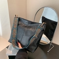 Retro black large-capacity shoulder bag with ethnic patterned wide strap on a table - Black