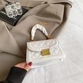 Detail of white quilted handbag with golden lock and ruched fabric handle texture - White