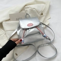 Detail of silver metallic PU leather backpack with pink drawstring and fashion logo - Silver